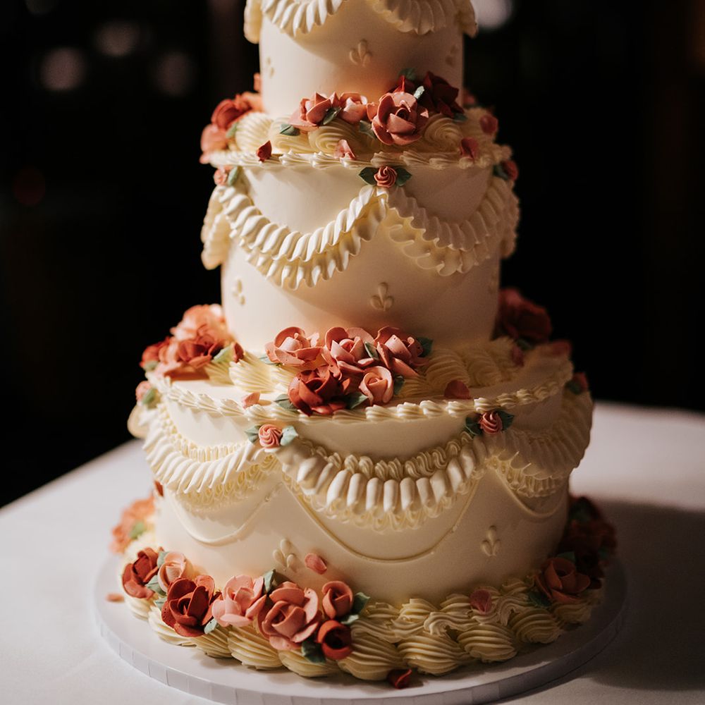 Retro styled wedding cake complete with white frosting and pink frosted roses 