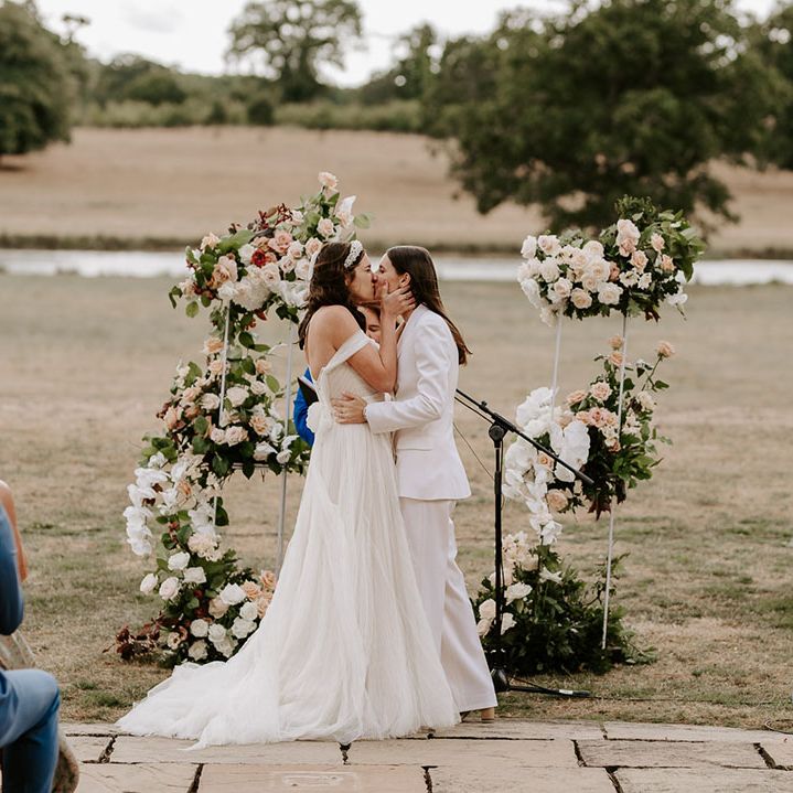 The brides share their firs kiss as a married couple at their outdoor ceremony at the Wilderness Reserve 