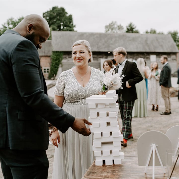 Wedding guests socialise and play the lawn games outside for fun 