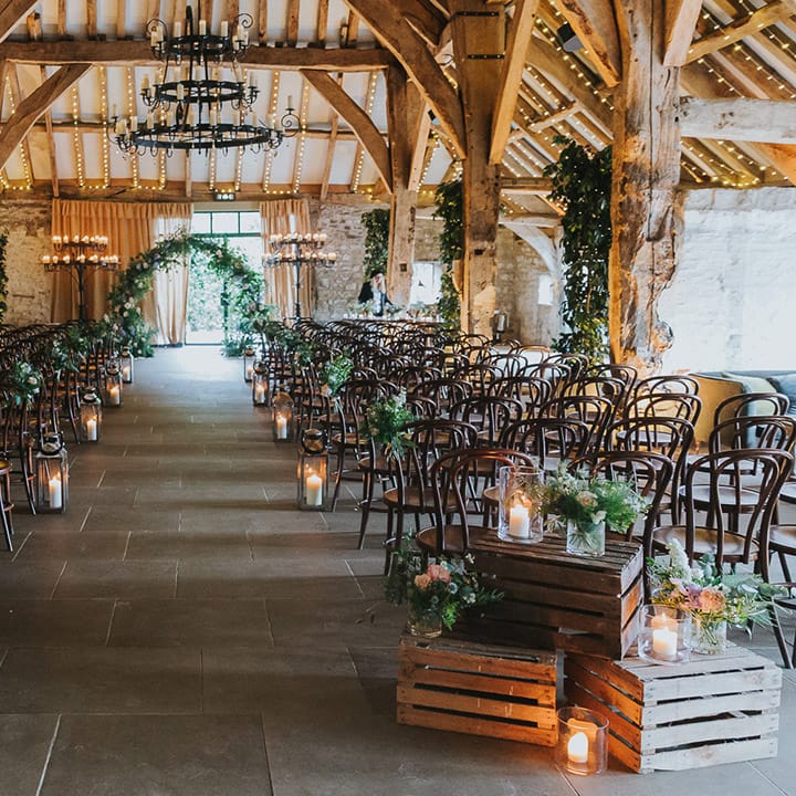 The Tithe Barn Bolton Abbey, Yorkshire wedding ceremony flowers and candle decor 