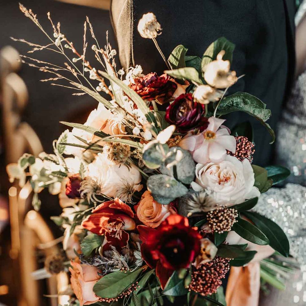 Mixed neutral bouquet with garden roses, carnations, peonies, eucalyptus, baby's breath and dried flowers tied with mustard velvet ribbon 