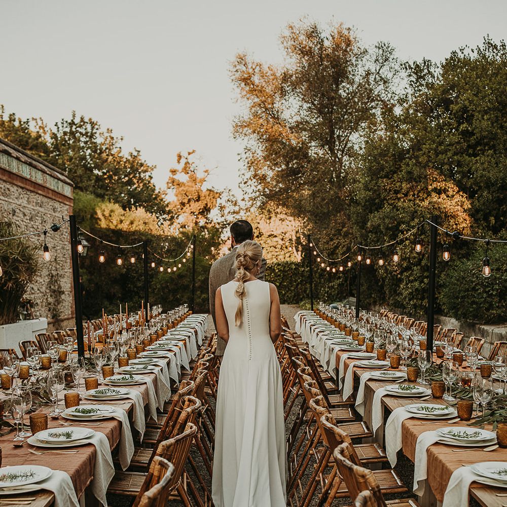 Bride and groom standing at their outdoor wedding reception 