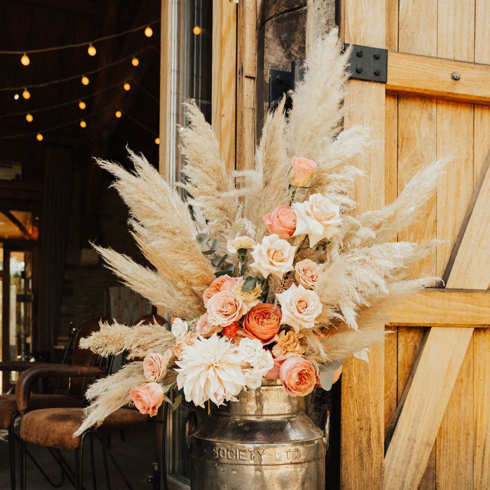 Pampas grass and white and pink rose boho luxe floral arrangement