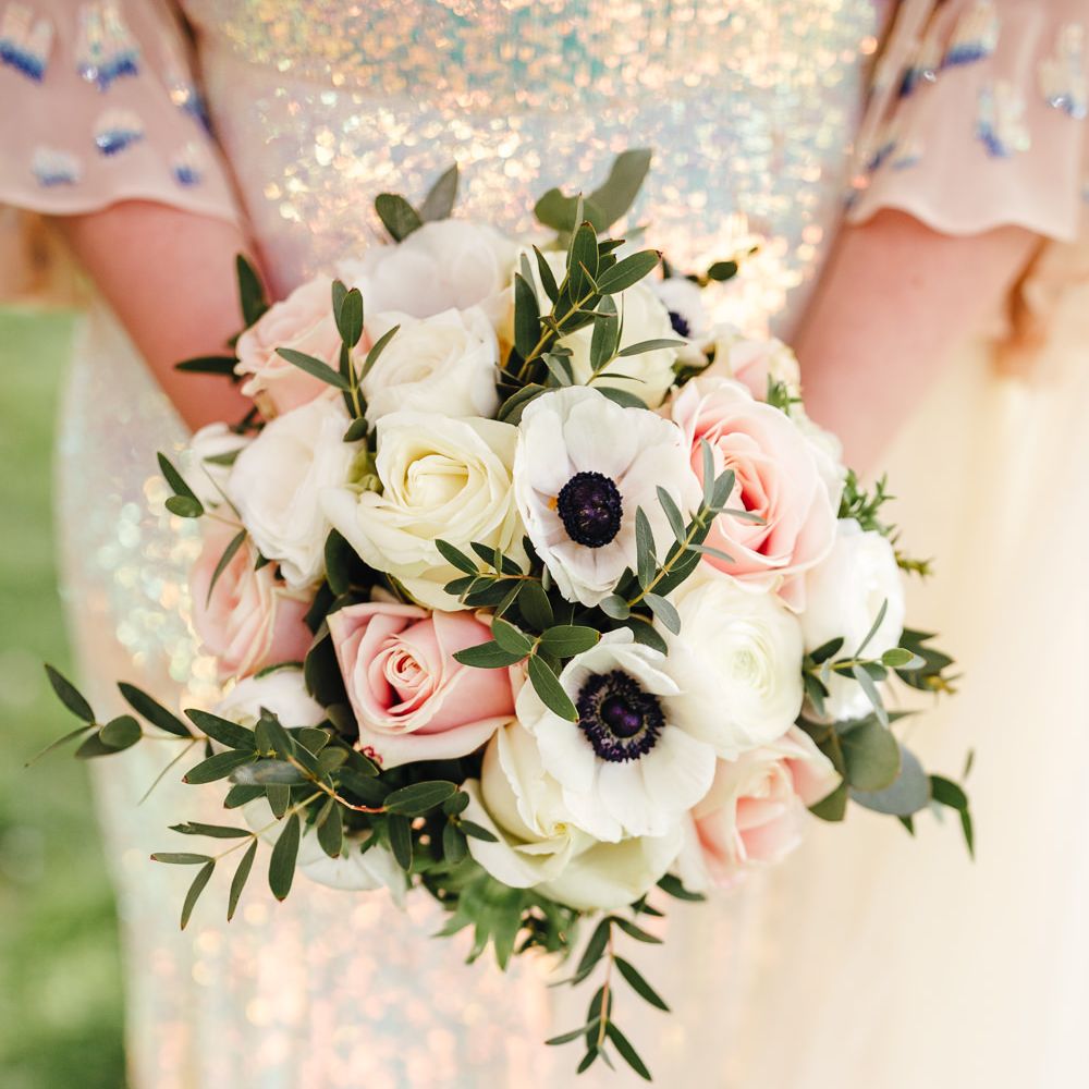 Brides floral bouquet featuring pale pink and white roses