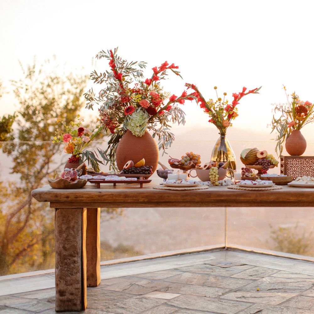 Greek food grazing table overlooking a view of Portaria as the sun begins to set