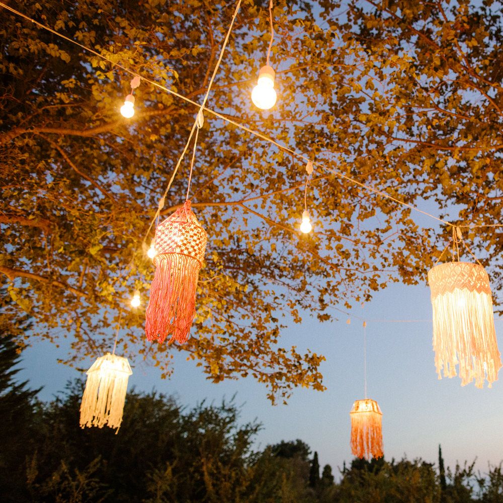Hanging lanterns from trees to illuminate the dance floor as the sun goes down