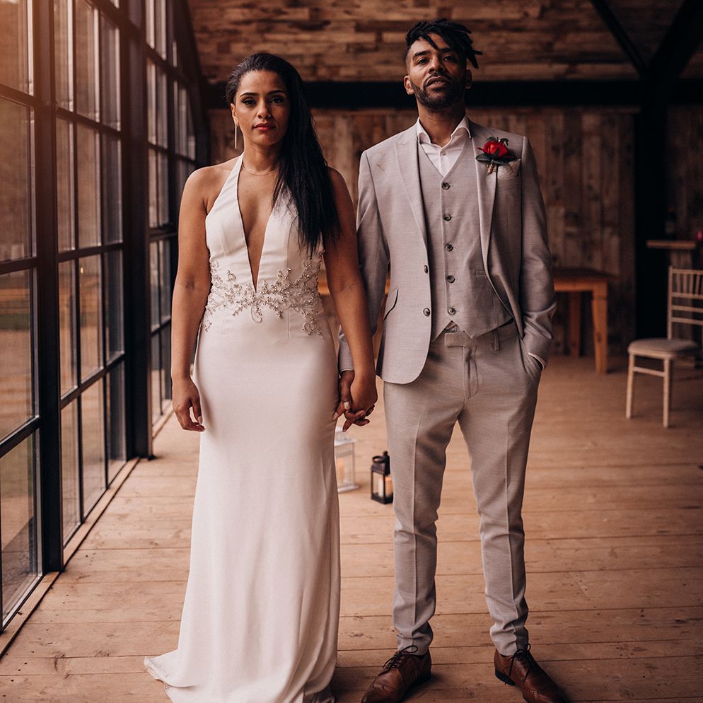 Bride & groom stand together on wedding day side by side 