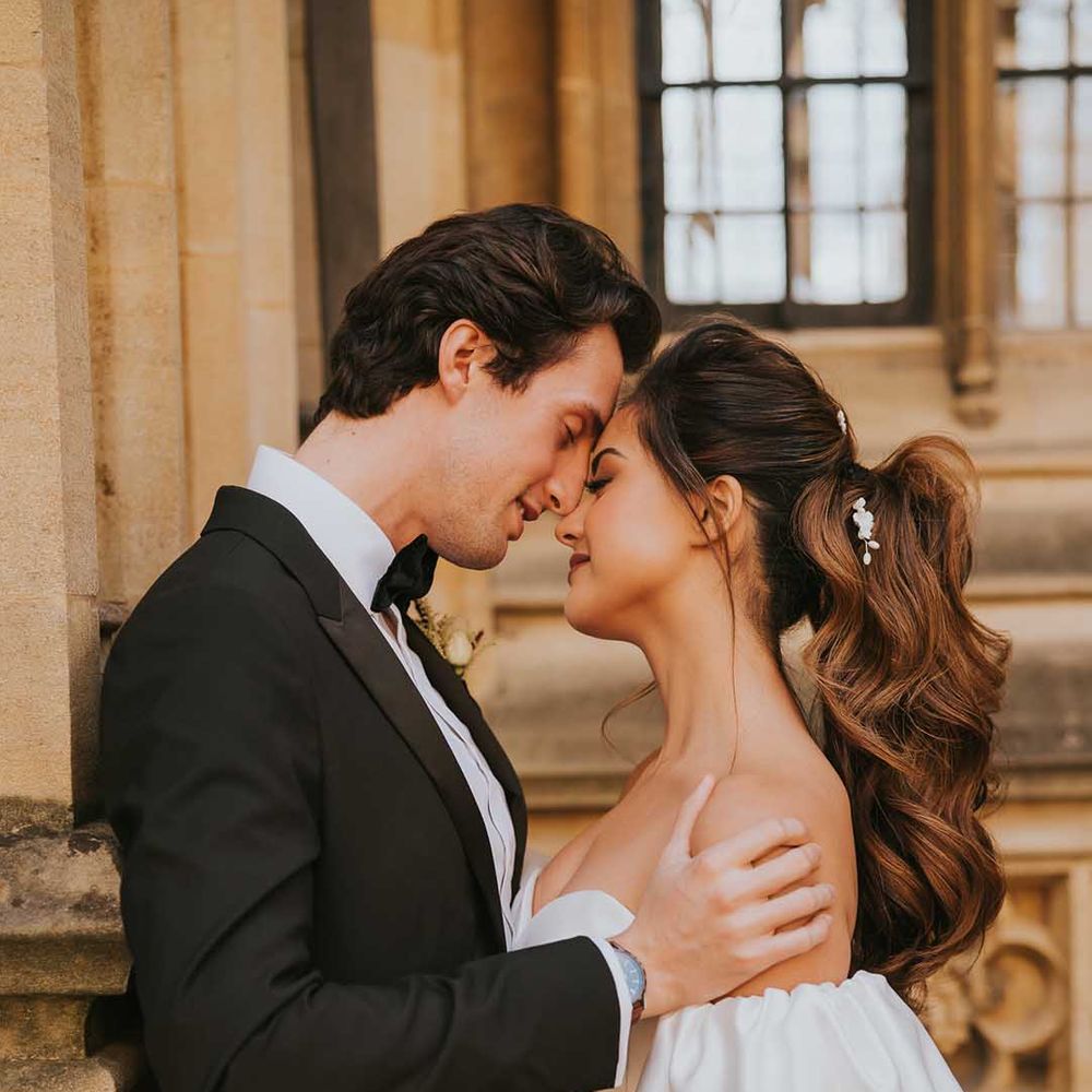Intimate bride and groom portrait with groom in a tuxedo and bride in a strapless wedding dress with puff sleeves