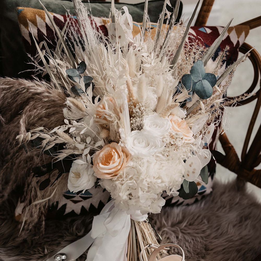 Dried floral bouquet complete with peach coloured roses