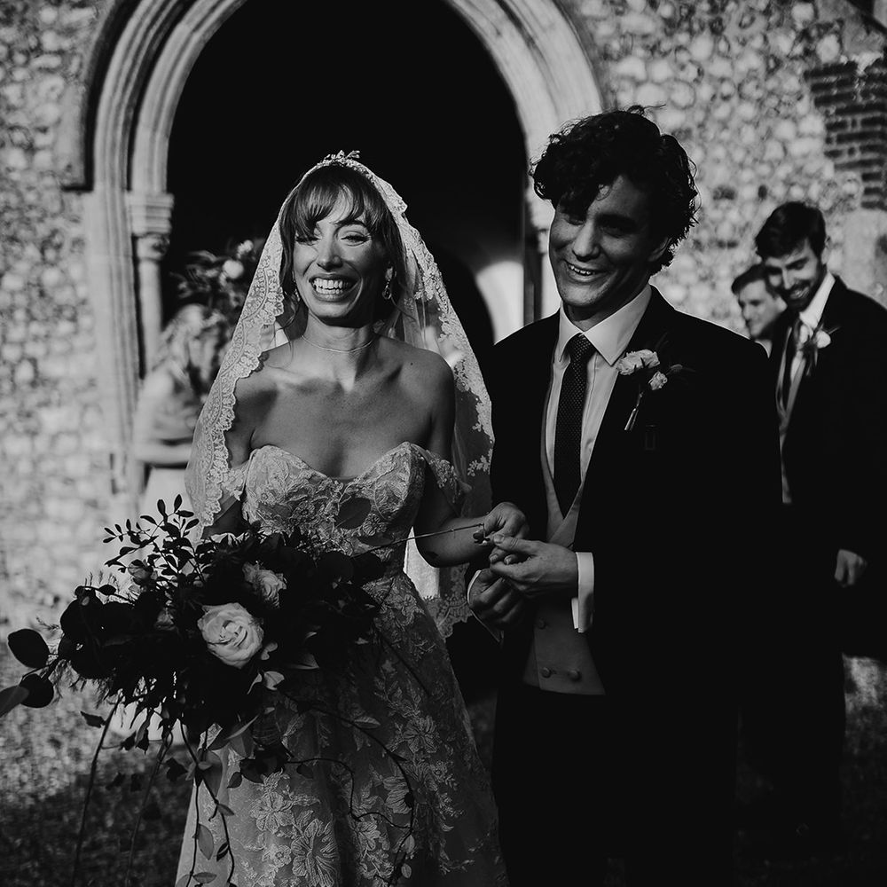 Bride and groom beam after church ceremony before they head to Oxnead Hall