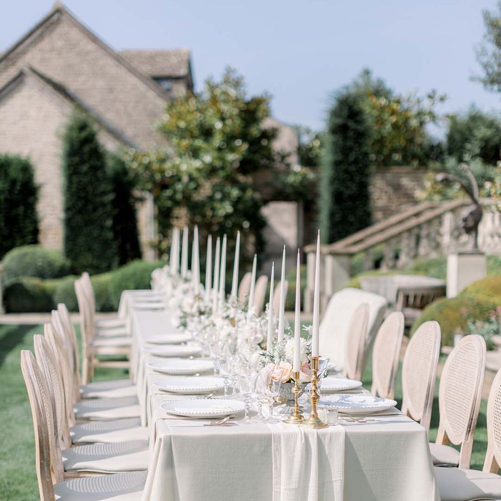 Simple white tablescape for grand table outdoors 