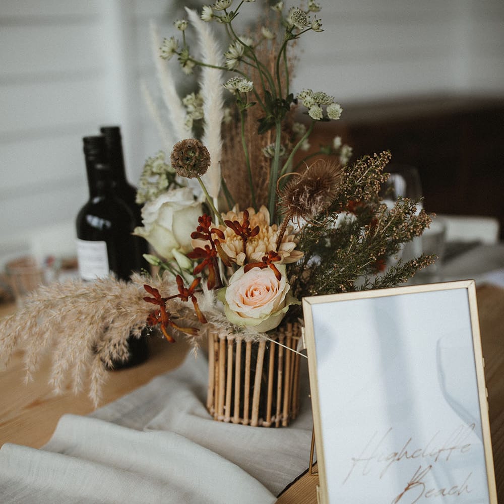 Dried florals on wooden table complete with fabric table runner 