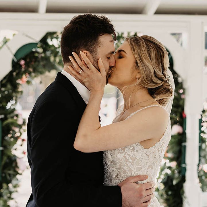 Bride and groom share their first kiss as a married couple 