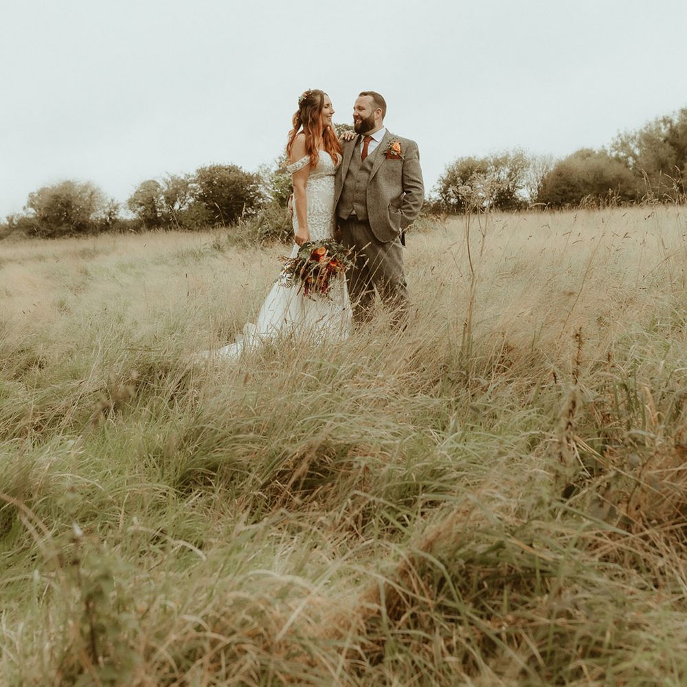 Bride and groom pose together for their couple portraits for their bouncy castle wedding 