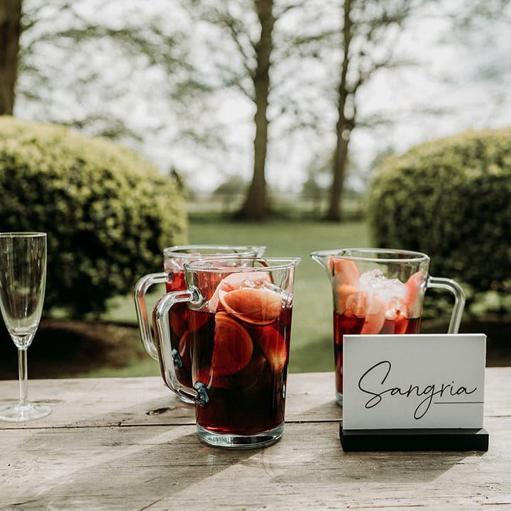 Sangria wedding drink in large jug with black and white table sign for outdoor wedding drinks 