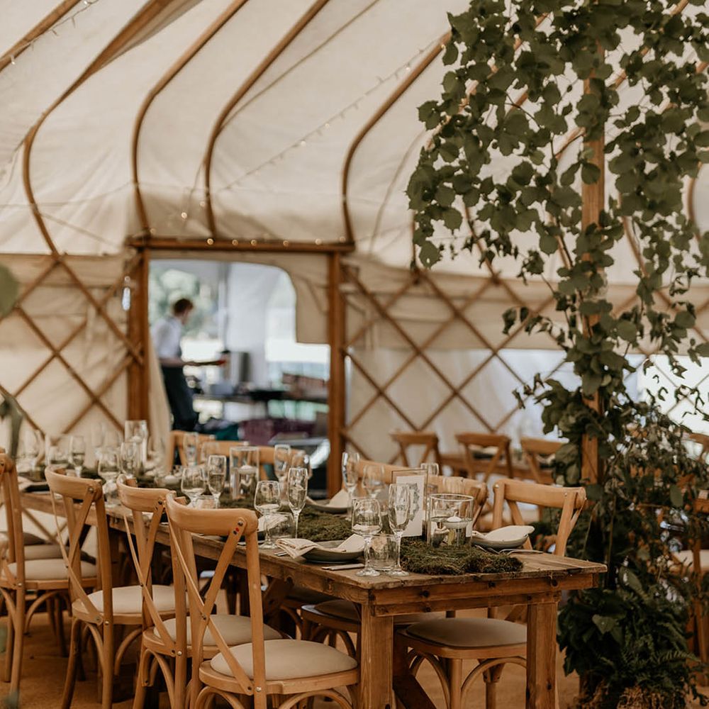 Moss wedding table runner with white tea lights and foliage decor yurt wedding reception 
