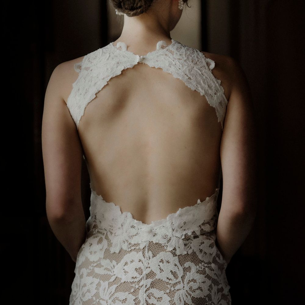 Bride wearing open back lace wedding dress from Grace Loves Lace 