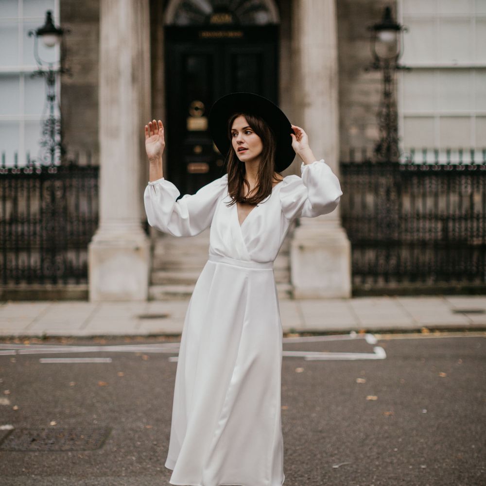Bride in wrap dress with fedora hat and silver boots 