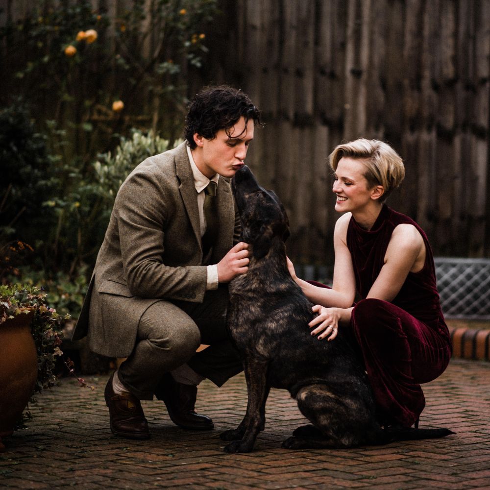 Wedding guests cuddle dog on the morning of wedding