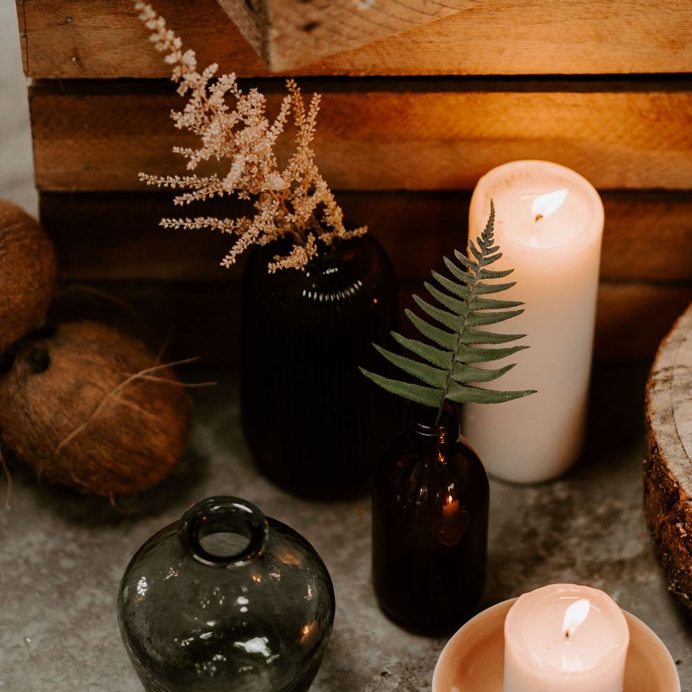 Coloured vases and pillar candles for tropical wedding theme