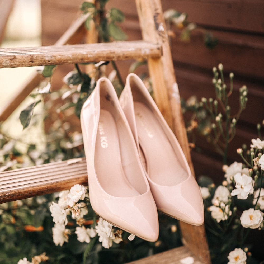 Neutral wedding shoes on a step ladder.