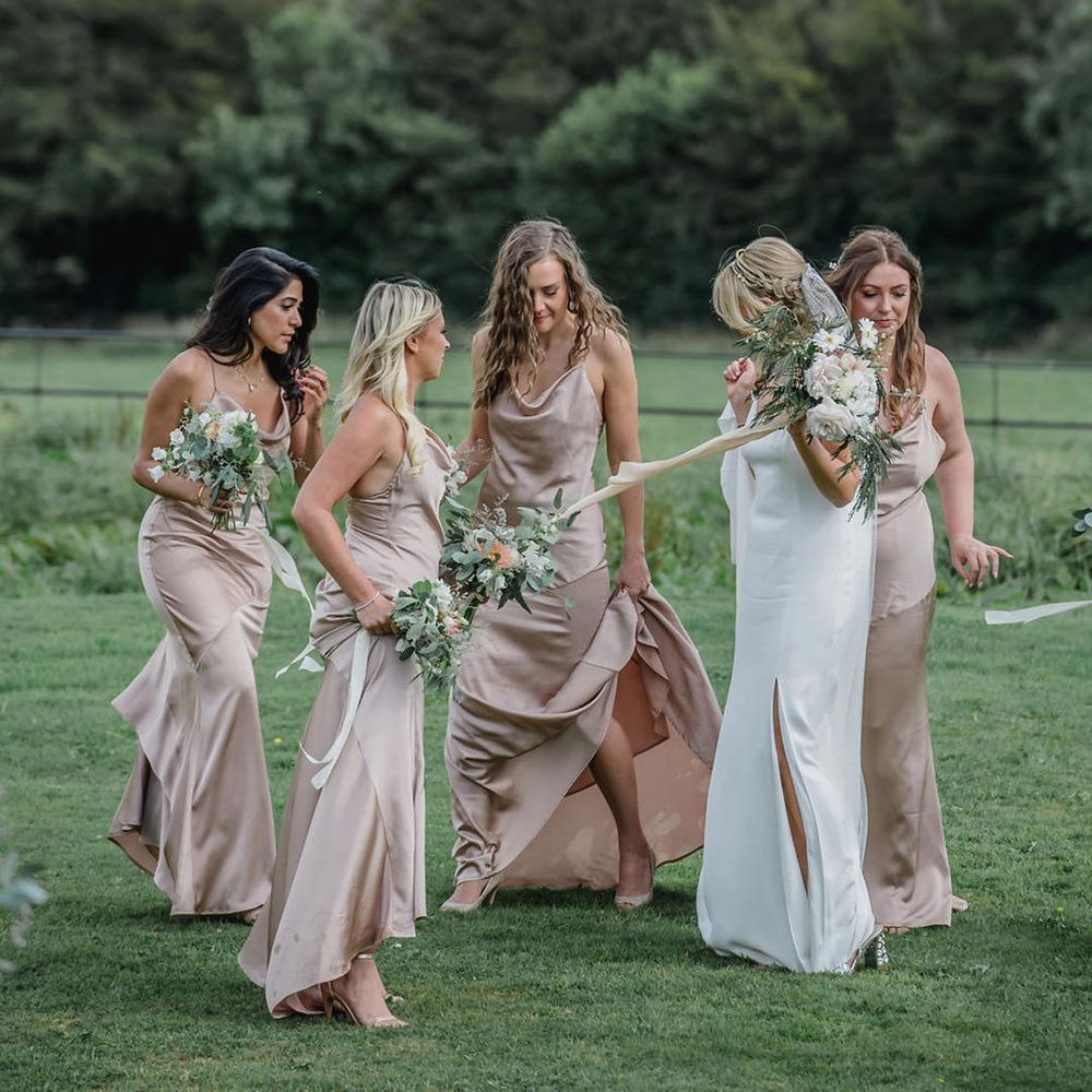Bride with bridesmaids in pink dresses at Trevenna Barns Cornwall