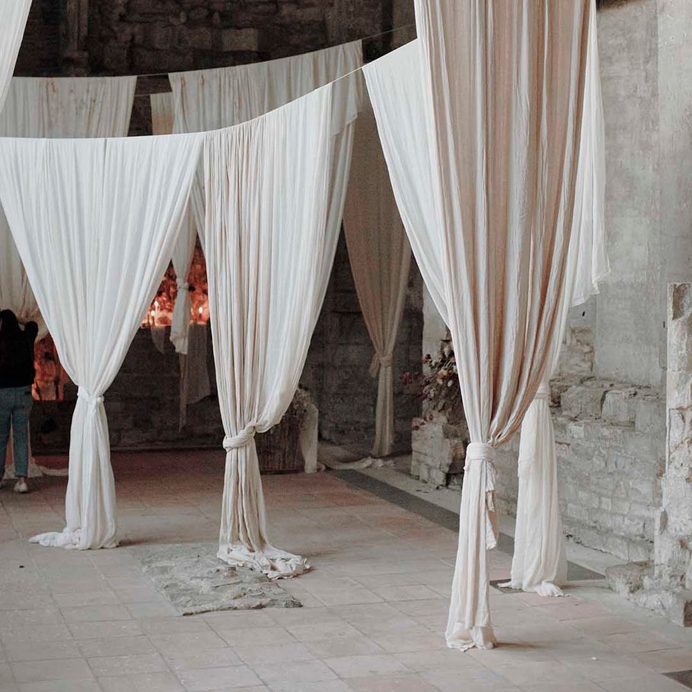 Hanging fabric installations in neutral tones at modern Blackfriars Priory wedding 