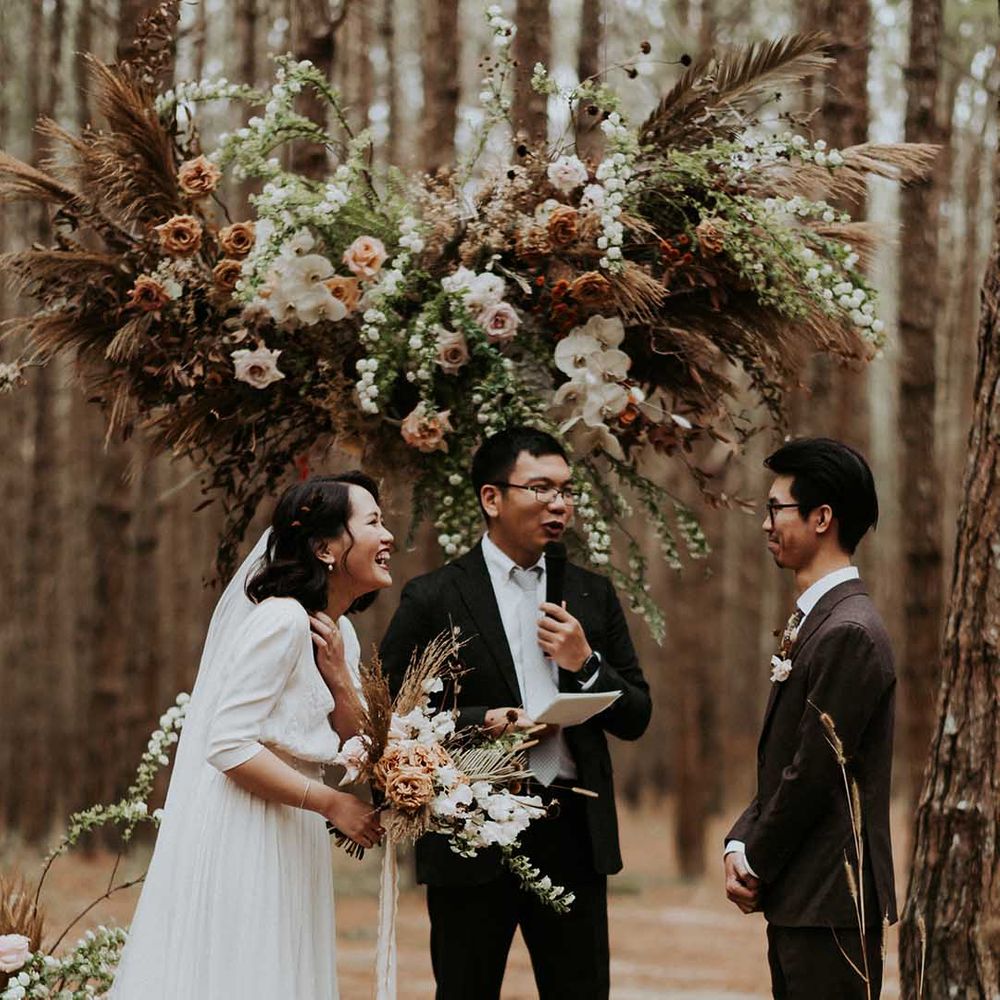 Woodland civil wedding ceremony with a wooden altar and flower installation  