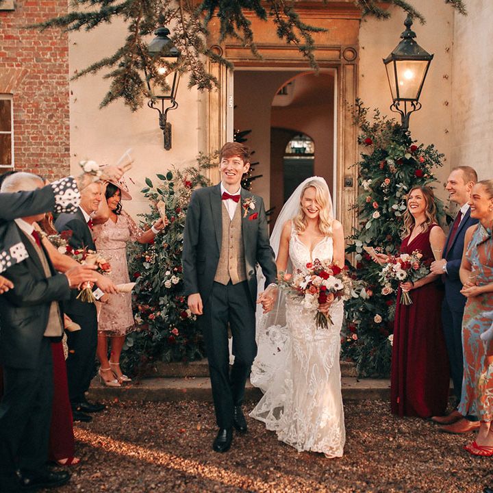 Winter Christmas wedding with the bride and groom walking out to confetti 