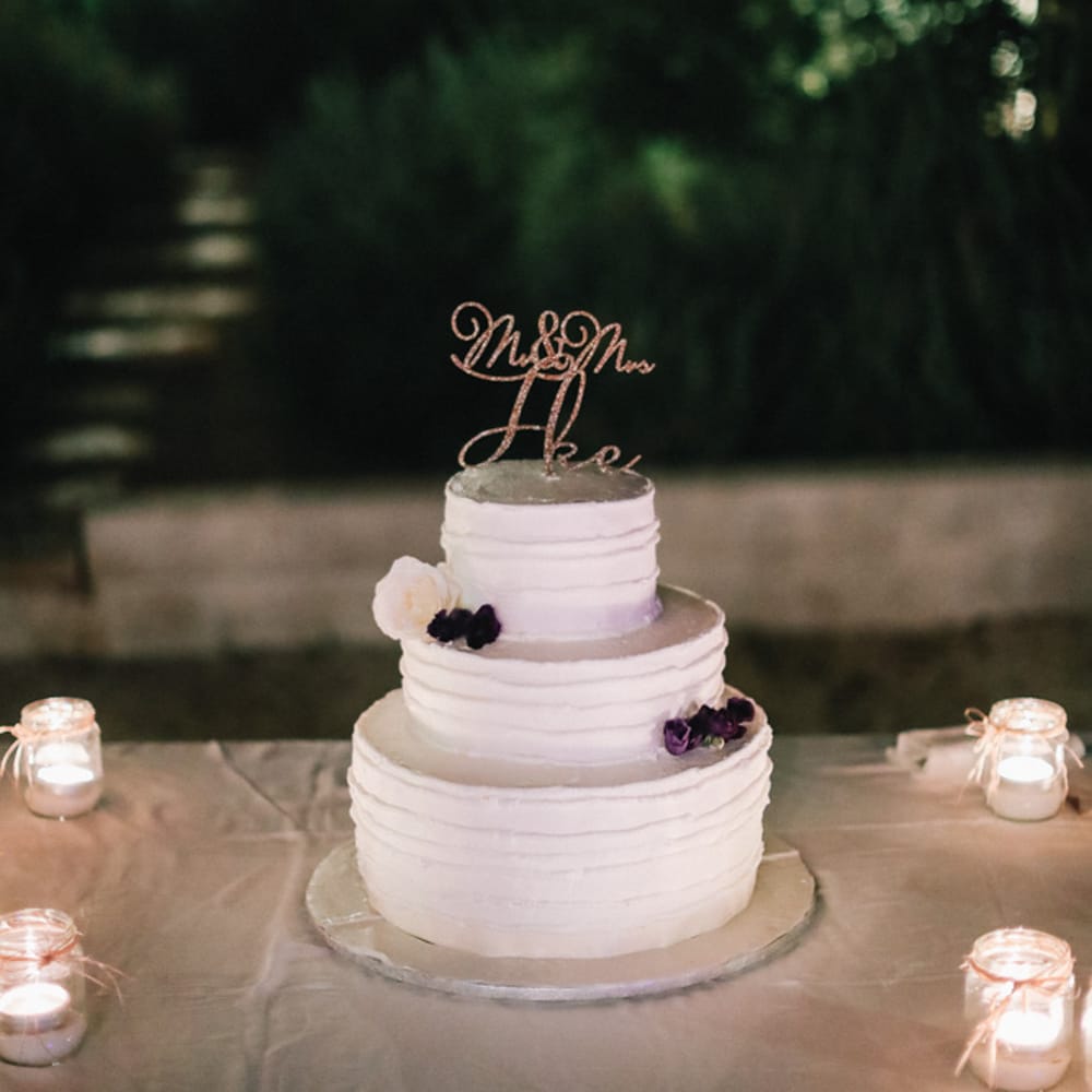 Three tier wedding cake with purple flowers for Italian wedding