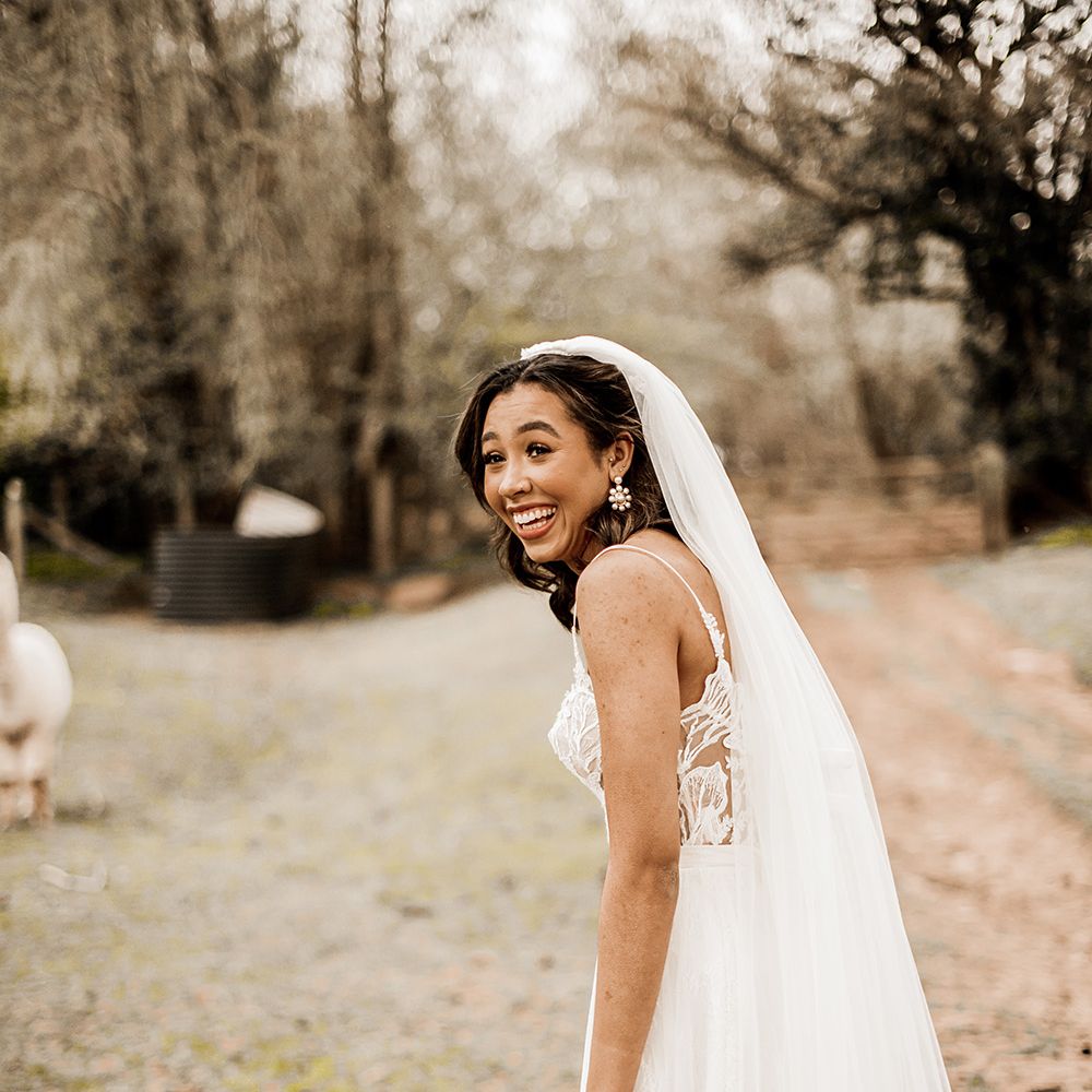 Beautiful bride in a tulle skirt wedding dress with long veil 