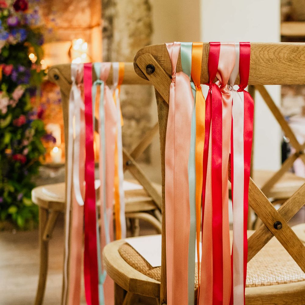 Colourful ribbon chair back decor at fiesta theme wedding 