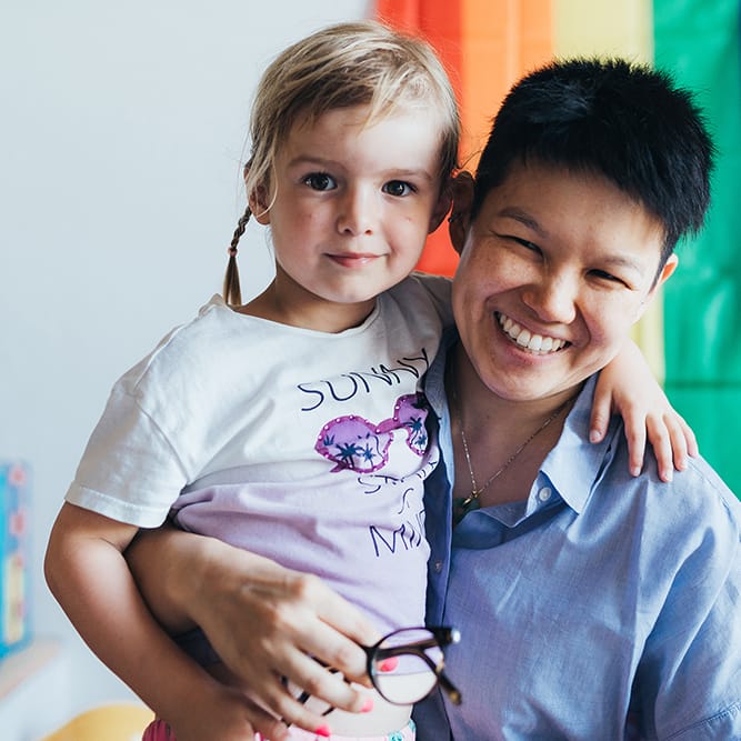 Bride poses for photo with little boy on her wedding day