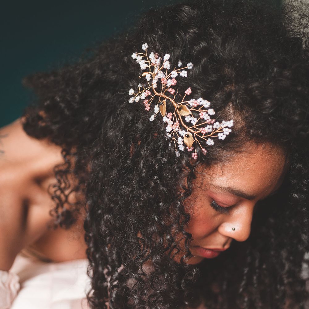 black bride with naturally curly hair wearing a wire hair accessory 