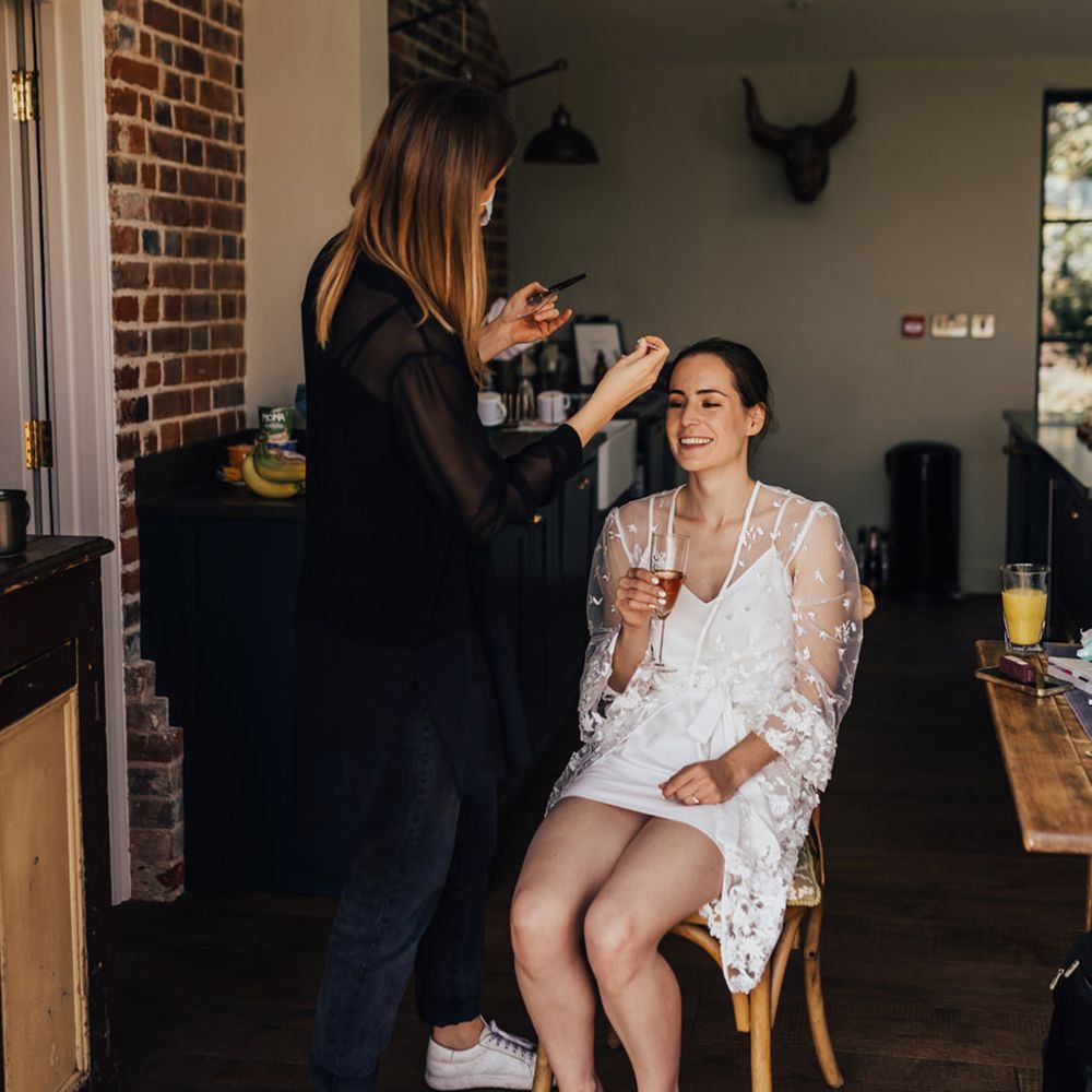 Bride having hair up do & make up in bridal sequin unique bridal dressing gown  