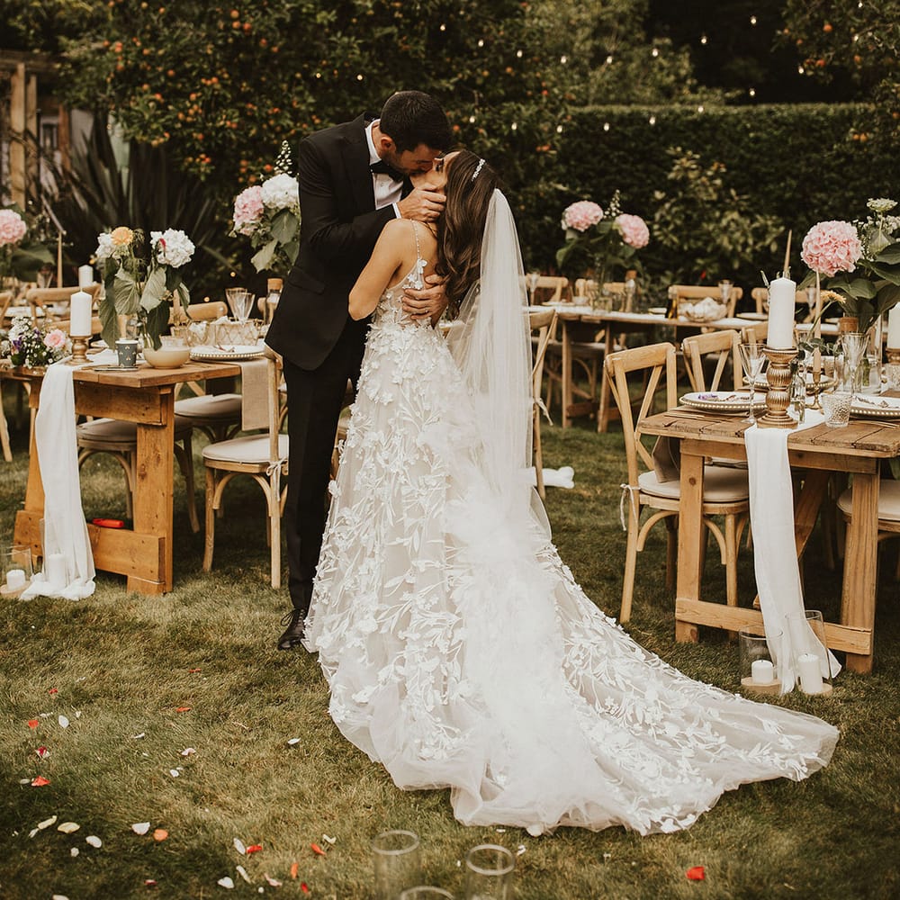 Bride & groom kiss outdoors on their wedding day