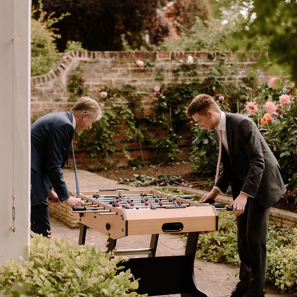 Wedding guests play table football