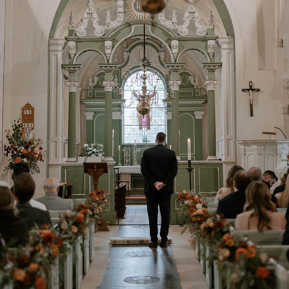 Groom awaits bride's arrival at church wedding ceremony
