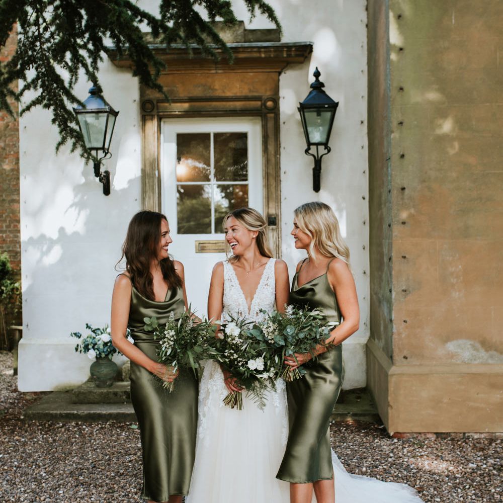 Bridal party in satin sage green bridesmaid dresses 