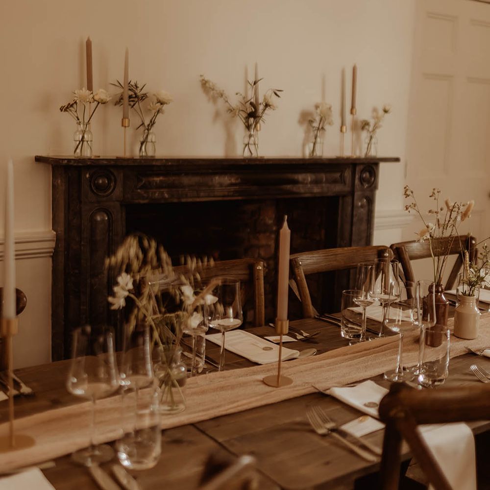 Minimal and simple decor for boho luxe wedding with bunny grass and other dried flowers and neutral coloured candles 
