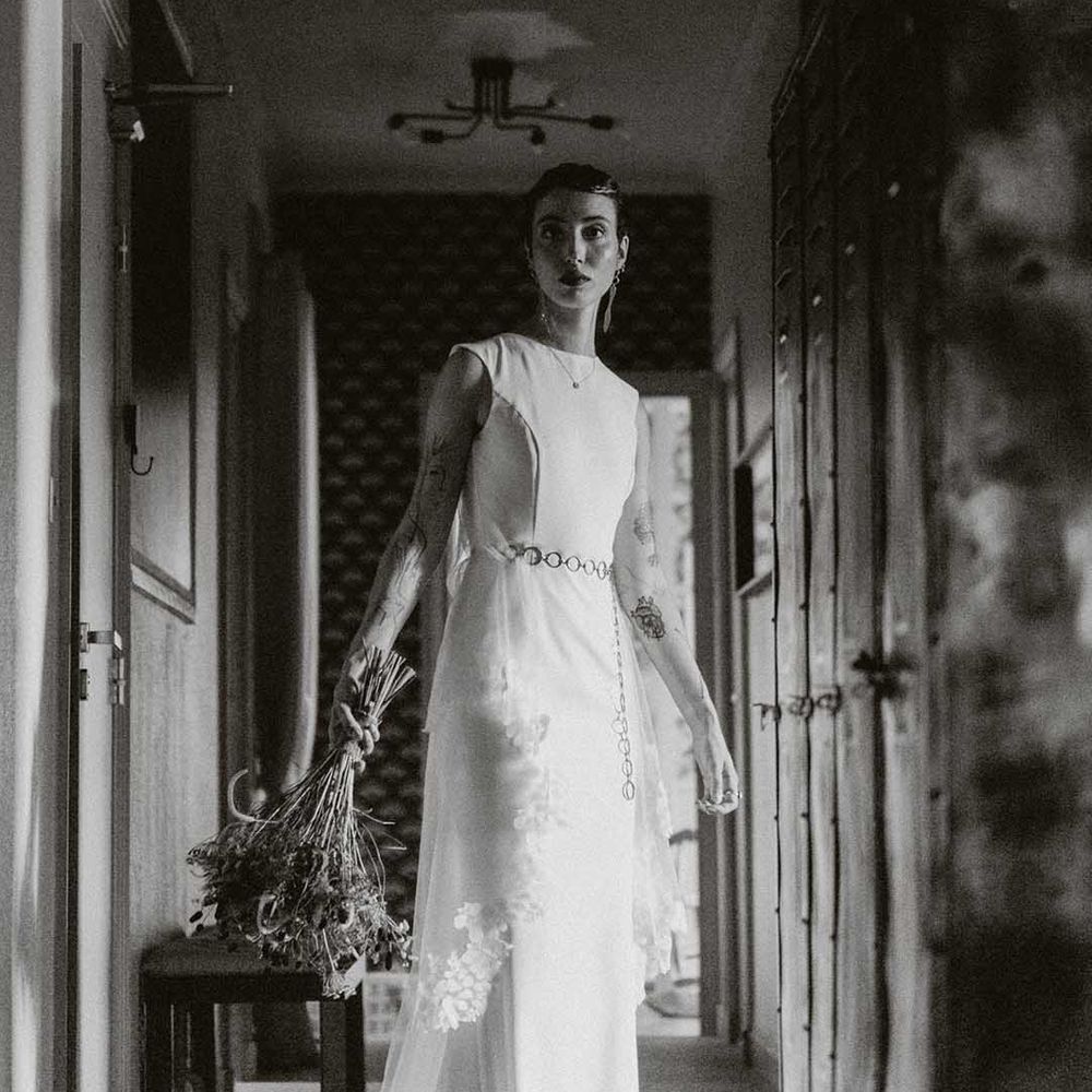 Lisa wears fitted wedding dress with bateau neckline and chain styled belt