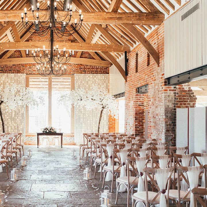 Rackleys Chiltern Hills barn wedding venue in Buckinghamshire with white blossom trees decorating the altar 