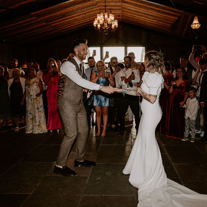 The bride and groom have their first dance together at rustic barn wedding venue in the East Midlands 