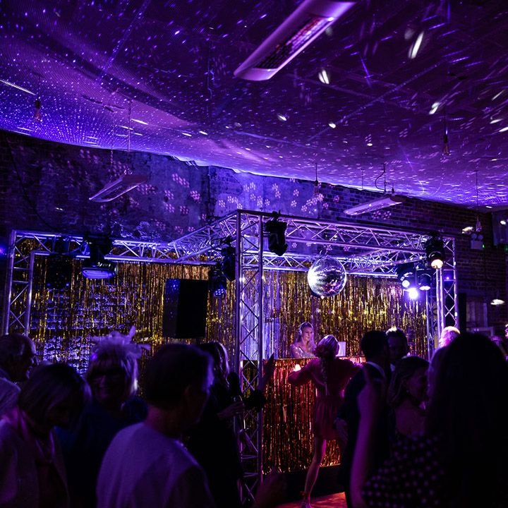 DJ plays at wedding reception with laser lights and disco ball 