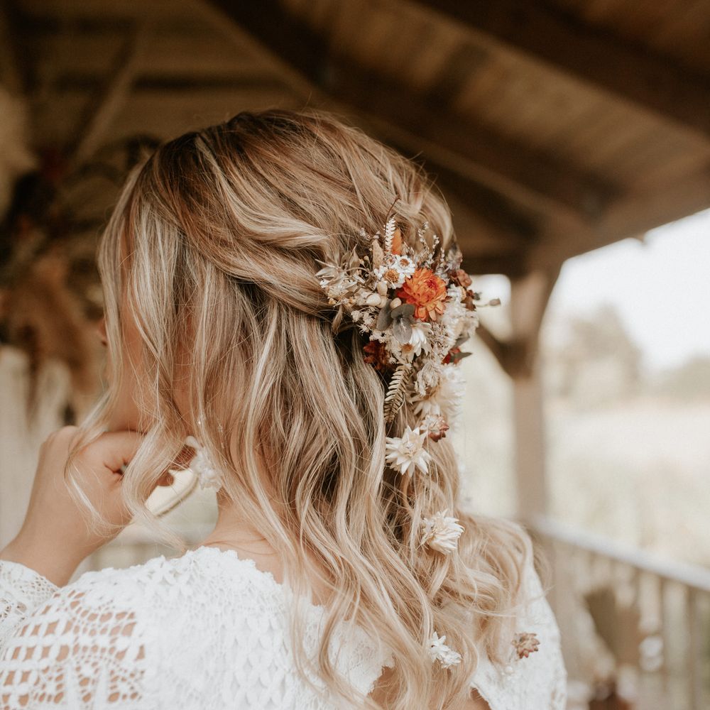 Boho chic hairstyling with floral accessories and loose curls 