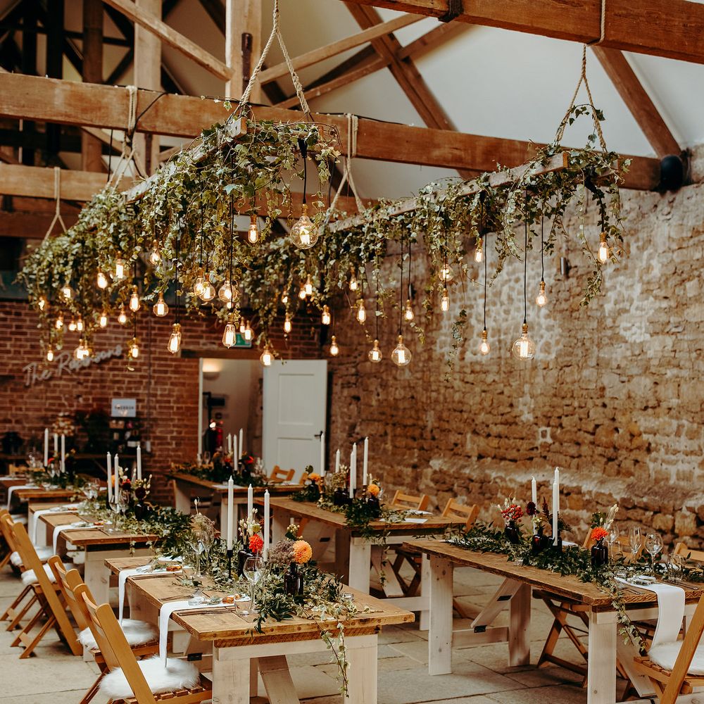 Rustic reception decor with hanging lights, Autumnal colour scheme and hanging ivy 