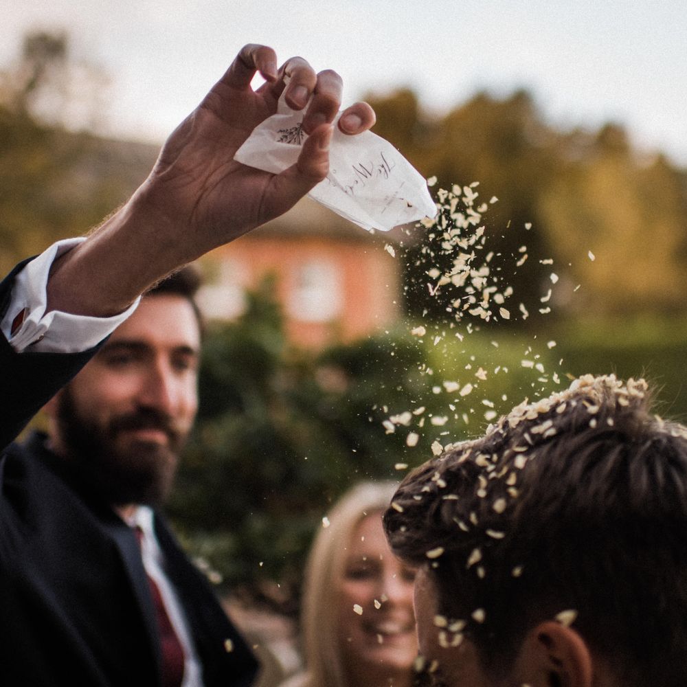 Wedding guest throws confetti 