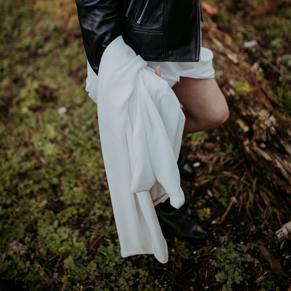 The bride wore a leather jacket and black boots to her winter wedding ceremony