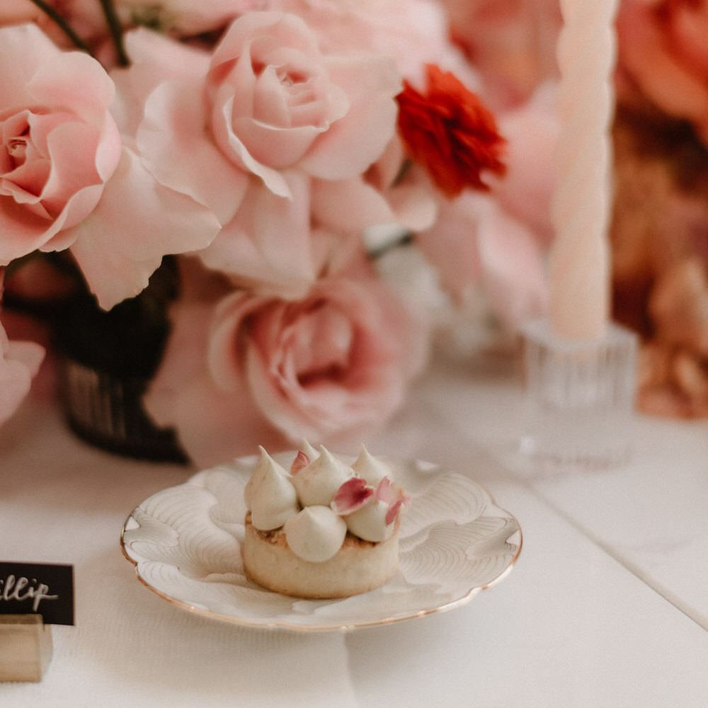 Pink and peach wedding flowers with a meringue topped pastry