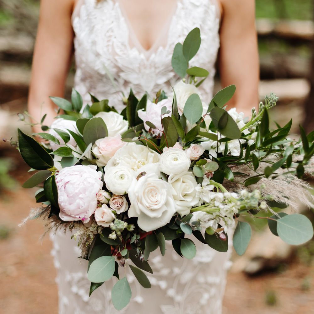 White and blue pink bridal bouquet with roses, peonies and green leaves for backyard wedding